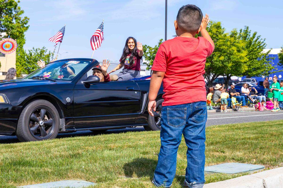 Five-year-old Abel Rodriguez waves to parade royalty during Pasco’s Cinco de Mayo parade on Saturday in downtown Pasco.