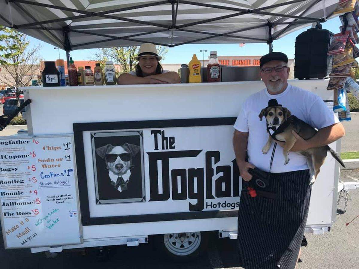 Malinda Ralson and Troy Collins run the Dogfather food cart on 27th Avenue in front of PetCo in Kennewick. They are expanding with a food truck that will be on Clearwater Avenue in front of Bella’s Office Furniture. They are shown with their dog Max - the inspiration for the name.