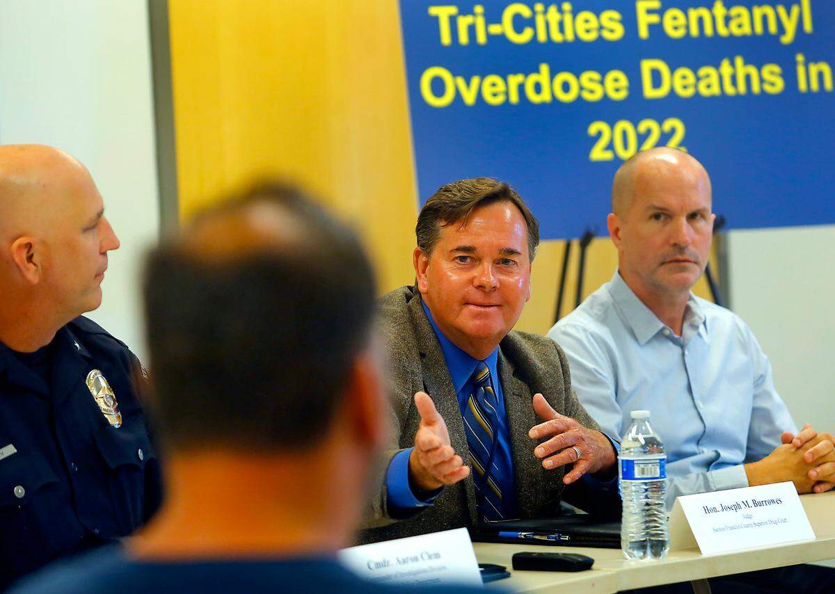 Benton Franklin Superior Court Judge Joseph Burrowes proudly acknowledges drug court graduate Shaun Lettrick during the fentanyl roundtable discussion hosted by Sen. Maria Cantwell in Kennewick.