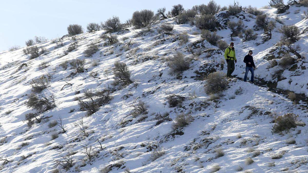 Hikers make their way down Badger Mountain. More snow is possible starting Saturday night.