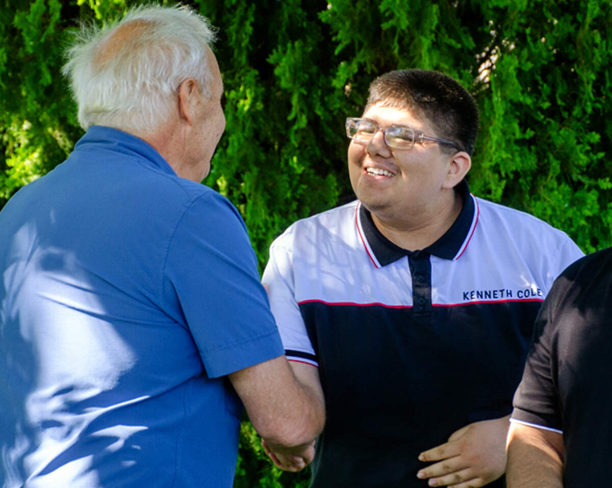 Salvador Camacho Campos, 17, of Pasco, thanks retired Benton County Prosecutor Andy Miller during a sit-down visit on Sunday, June 7. Miller sought justice for the family in the 2008 murder of their matriarch, Araceli Camacho Gomez.