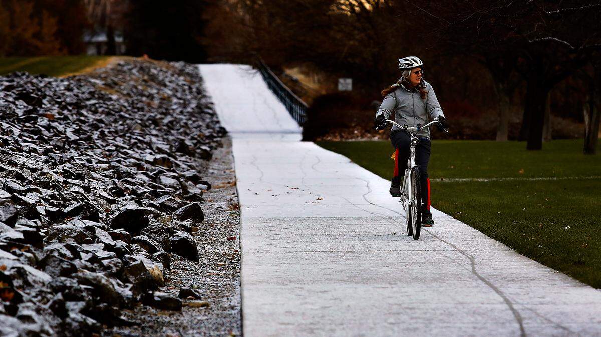 An early morning bicyclist leaves tracks in the overnight dusting of snow through Howard Amon along the Columbia River in Richland. Snowfall in the Tri-Cities seemed spotty but to the west it was causing delays and closures for some Yakima Valley schools and workplaces. The National Weather Services says Thursday will be cloudy with a 20% chance of snow in the morning, then mostly sunny in the afternoon with highs in the lower to mid 30s.