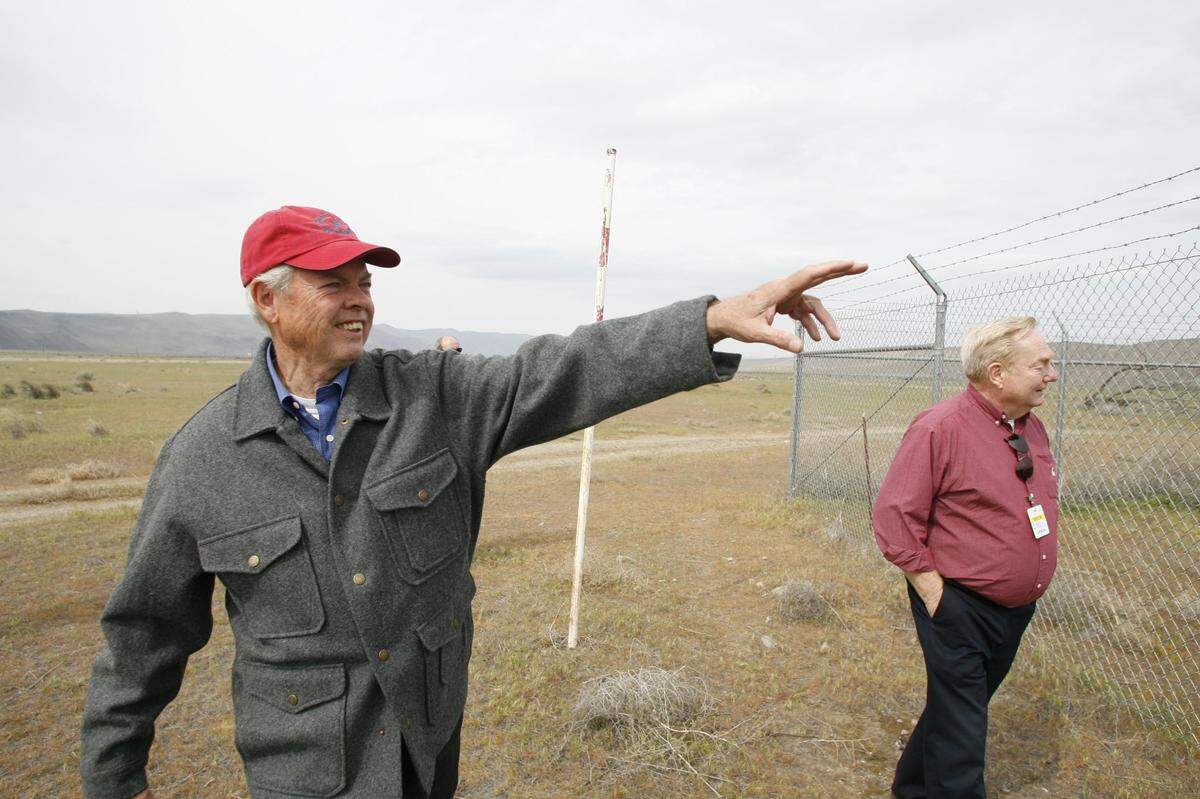 Ludwig Bruggemann points to features on the Bruggemann warehouse at Hanford as he walks with Gary Petersen, then TRIDEC vice president of Hanford projects and Hanford history buff.