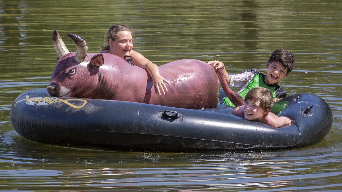 Alexandra Azevedo, left, Bryson Castillo, top, and Peyton Strampher, all of Walla Walla, battle one another to stay on top of an inflatable bull at Fish Hook Park about 20 miles from Burbank during a summer camp offered by Walla Walla Valley Camps. High temperatures are expected to hit 99 on Friday in the Tri-Cities, 100 on Saturday and 102 on Sunday.