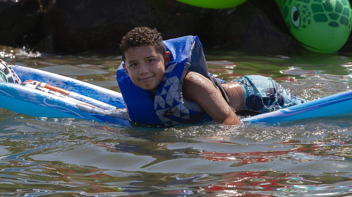 People bought pool toys and got into the Columbia River between the boat races and the air show as a way to beat the heat.