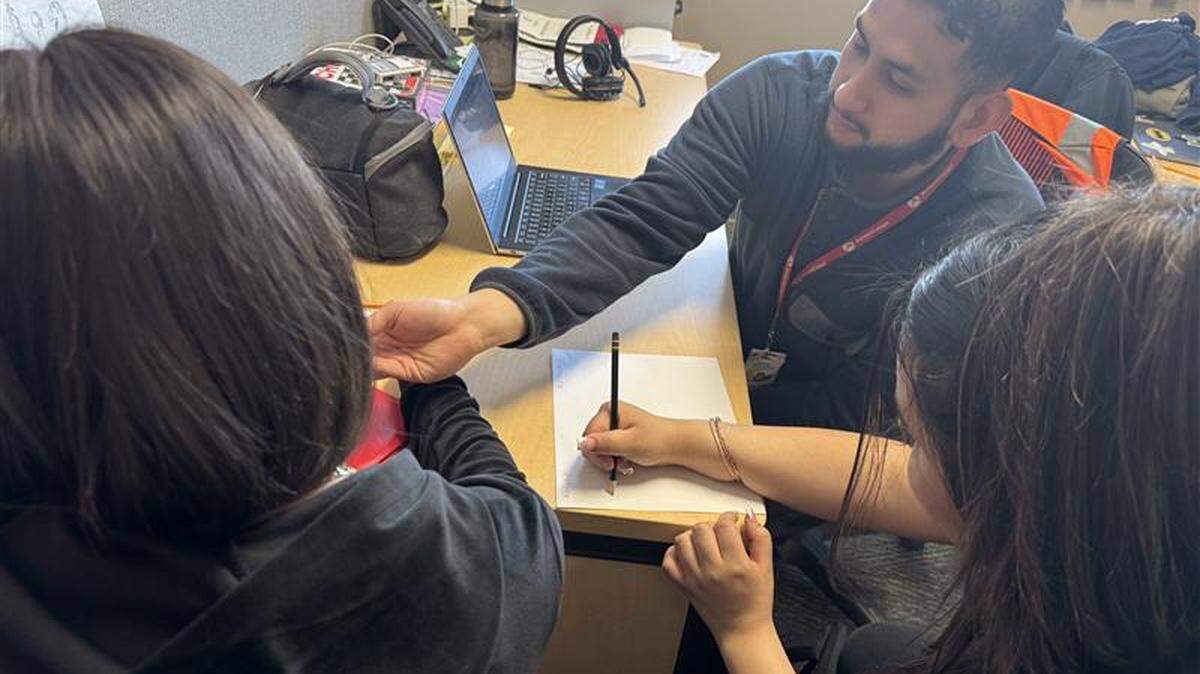 A previous mentor for the Attendance Matters program works with students at Stevens Middle School in Pasco.