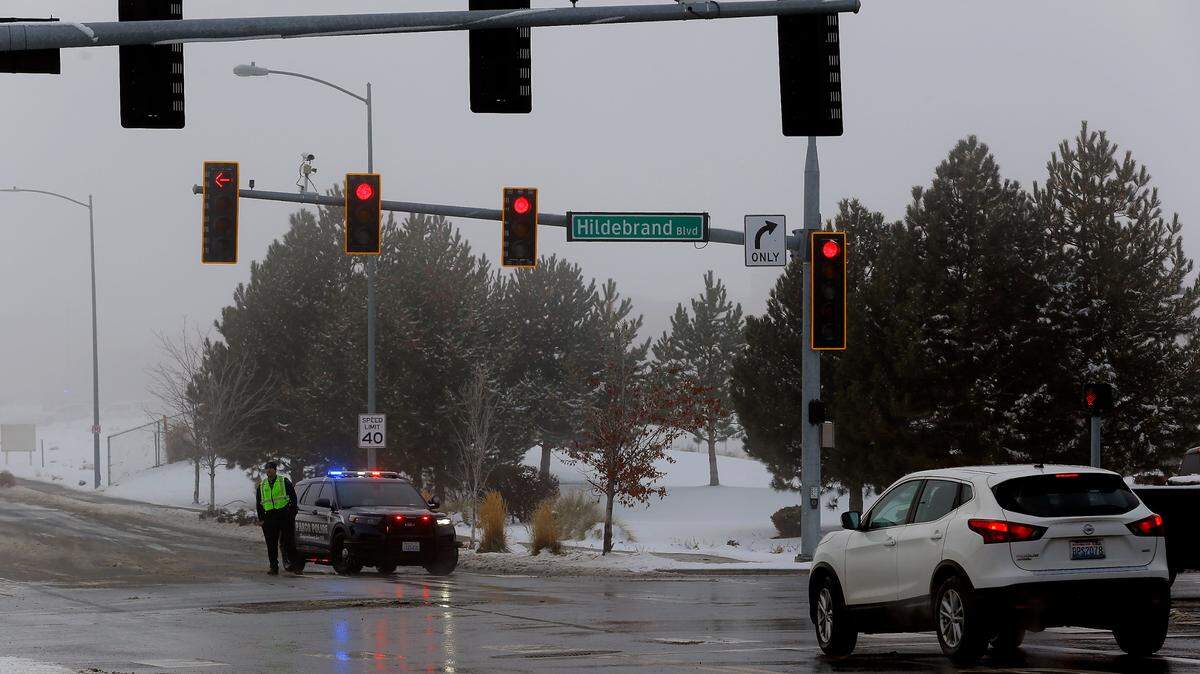 A Pasco police officer blocks the southbound lane of Southridge Boulevard at Hildebrand Boulevard as law enforcement officials search the Southridge High School campus after receiving a report of a firearm at the school.