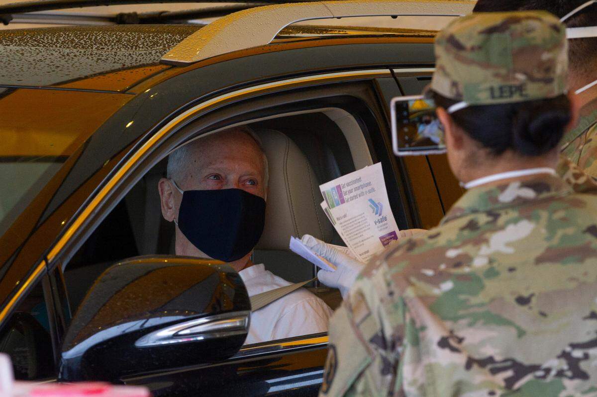 Former General James Mattis receives a coronavirus vaccine on Monday at the drive-thru COVID-19 vaccine site at the Benton County Fairgrounds. The National Guard is administering vaccines on a first come, first served basis to anyone eligible in the surrounding region.