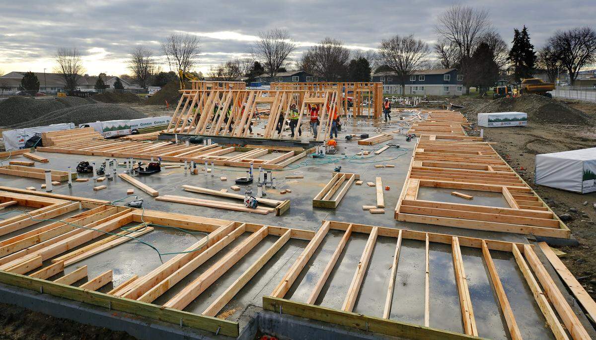 Framing crews lift a wall into place for a 114-unit garden-style apartment complex 1866 Jadwin Ave. in north Richland.