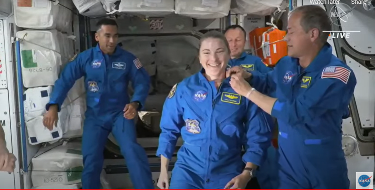NASA astronaut Kayla Barron received her pin as a NASA astronaut who has flown in space from astronaut Tom Marshburn shortly after boarding the International Space Station.