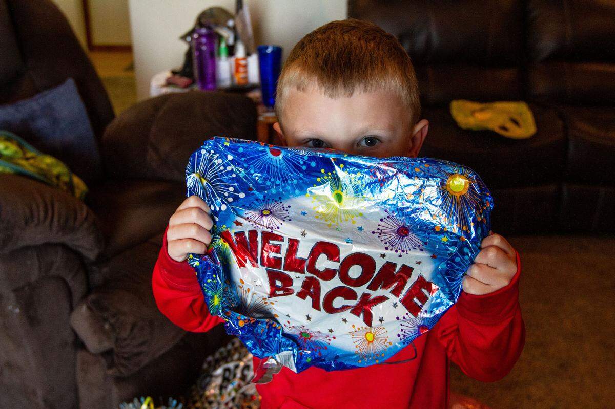 The Welch’s grandson, Kingston, holds up a ‘Welcome Back’ balloon from when the family greeted Mike on his return from the hospital in Boise.