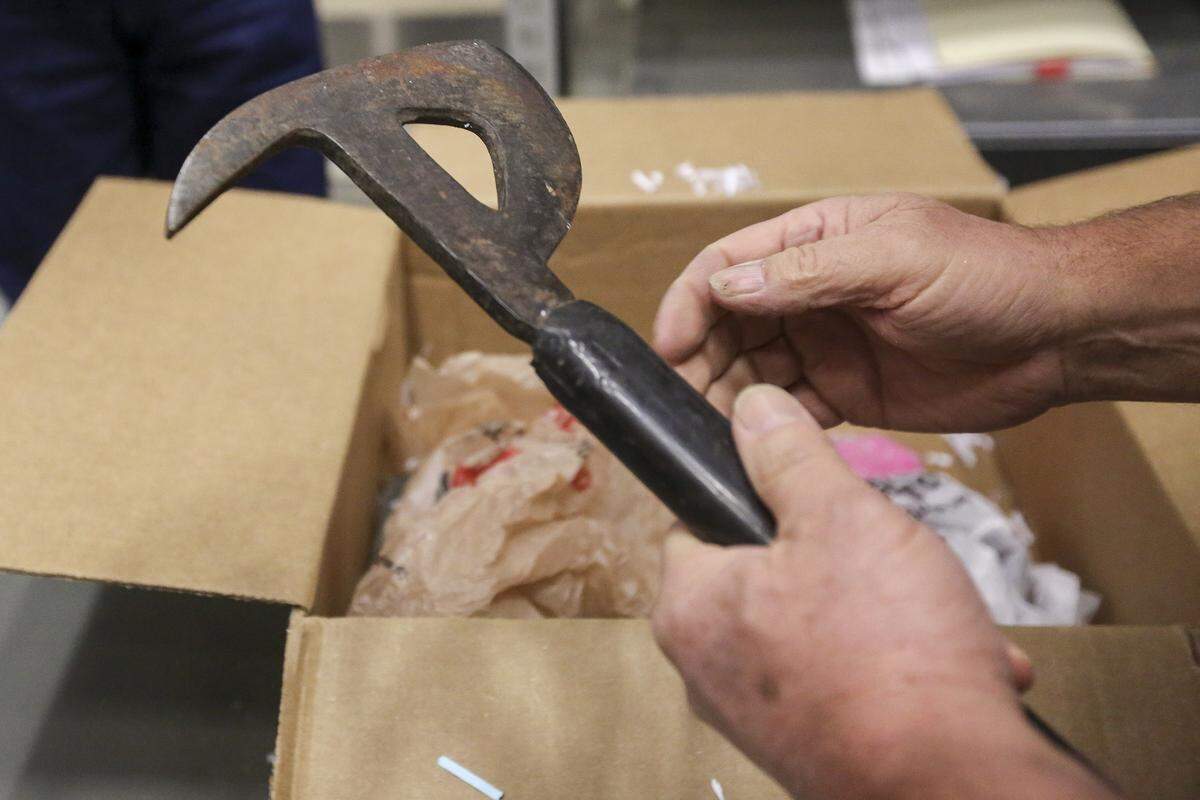 Local historian Donald Sorenson holds Day’s Pay B‑17 bomber pilot Arlys “Duane” Wineinger’s crash ax.