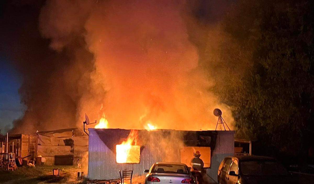 A two-alarm blaze on Haworth Road destroyed a shop, a home and three vehicles in a rural neighborhood Wednesday morning.