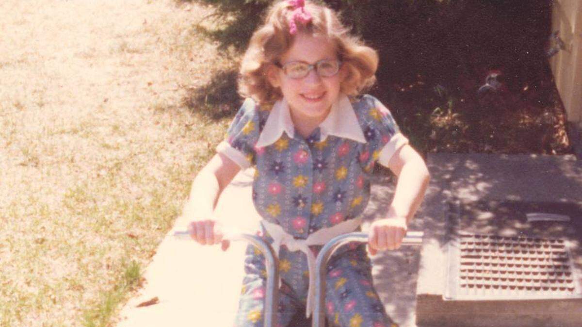 Jennifer rides her scooter in an early 1980’s photo.