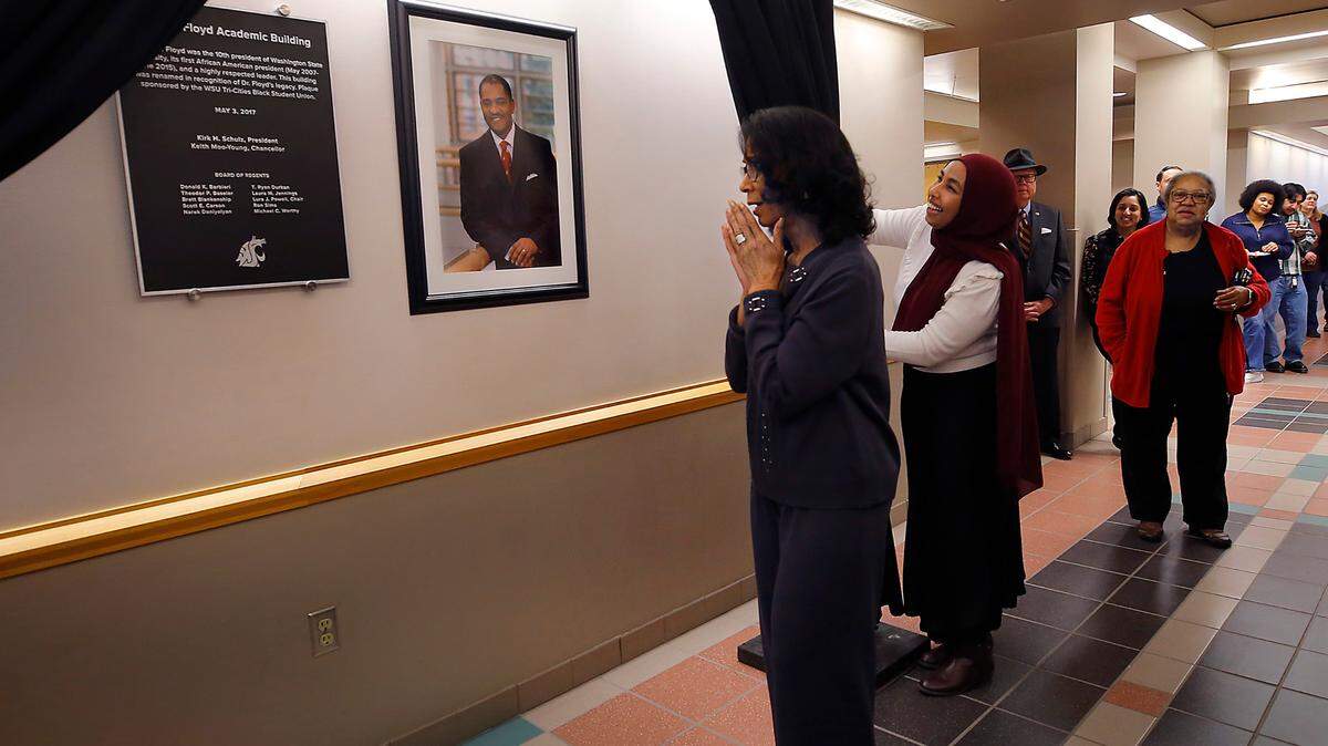 Carmento Floyd, the widow of Elson S. Floyd, reacts by holding her hands to her face after the unveiling of a portrait and plaque of Washington State University’s first Black president during a ceremony held in his honor at the WSU Tri-Cities campus in Richland. The Black History Month celebration was put on by the WSU Tri-Cities Black Union. About 60 people attended. 