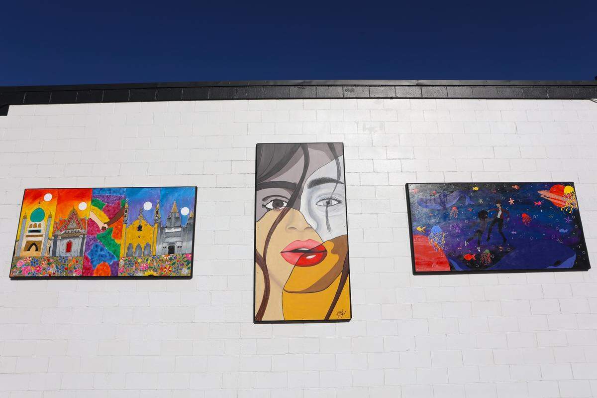 In 2024, Mike Miller invited three high school students to creat murals for his building. The murals, from left, are by Aleah Mahaffey, Ella Lehrman and Zahara Acevedo.