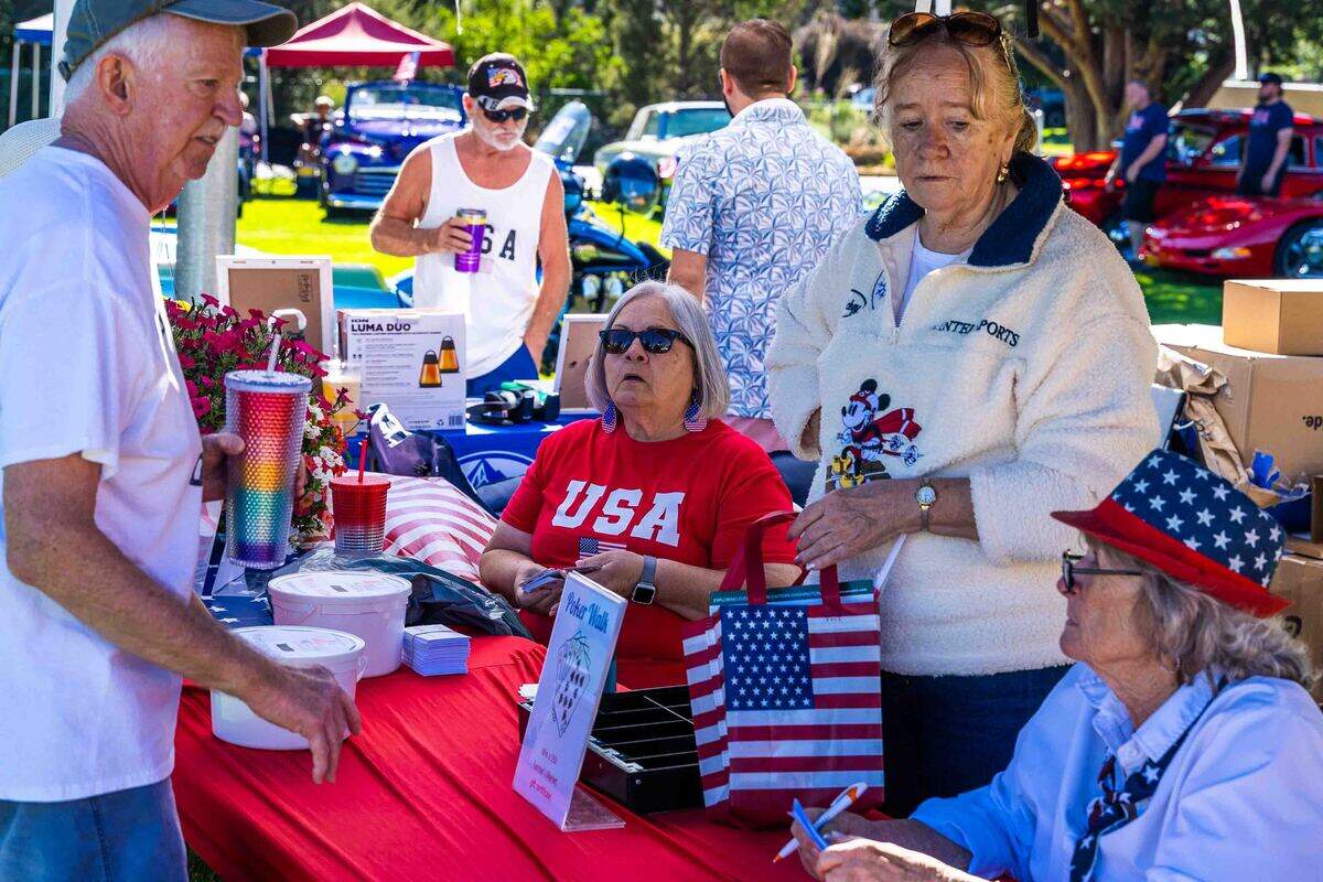 Volunteers assist visitors at a fundraising booth Saturday during Prosser’s Old-Fashioned Fourth of July celebration in Prosser City Park. Community organizations and service clubs hosted food, refreshments and activities throughout the day as residents gathered to celebrate Independence Day.