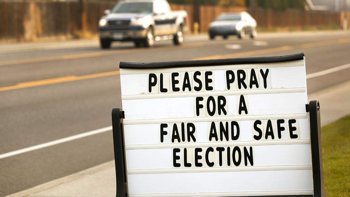 Motorists drive past a sign calling to pray for a fair and safe election at a Kennewick church in 2020.