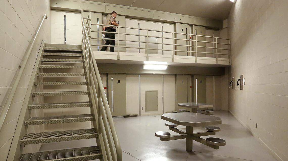 A Benton County Sheriff corrections officer inspects an empty pod at the Benton County Jail in Kennewick.