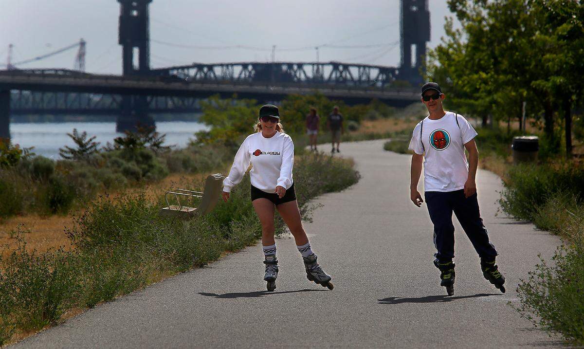 Crystal Juarez and her husband, Randy, get a rolling head start to the weekend during their weekly bridge-to-bridge outing on inline skates on the Kennewick side of the Columbia River.