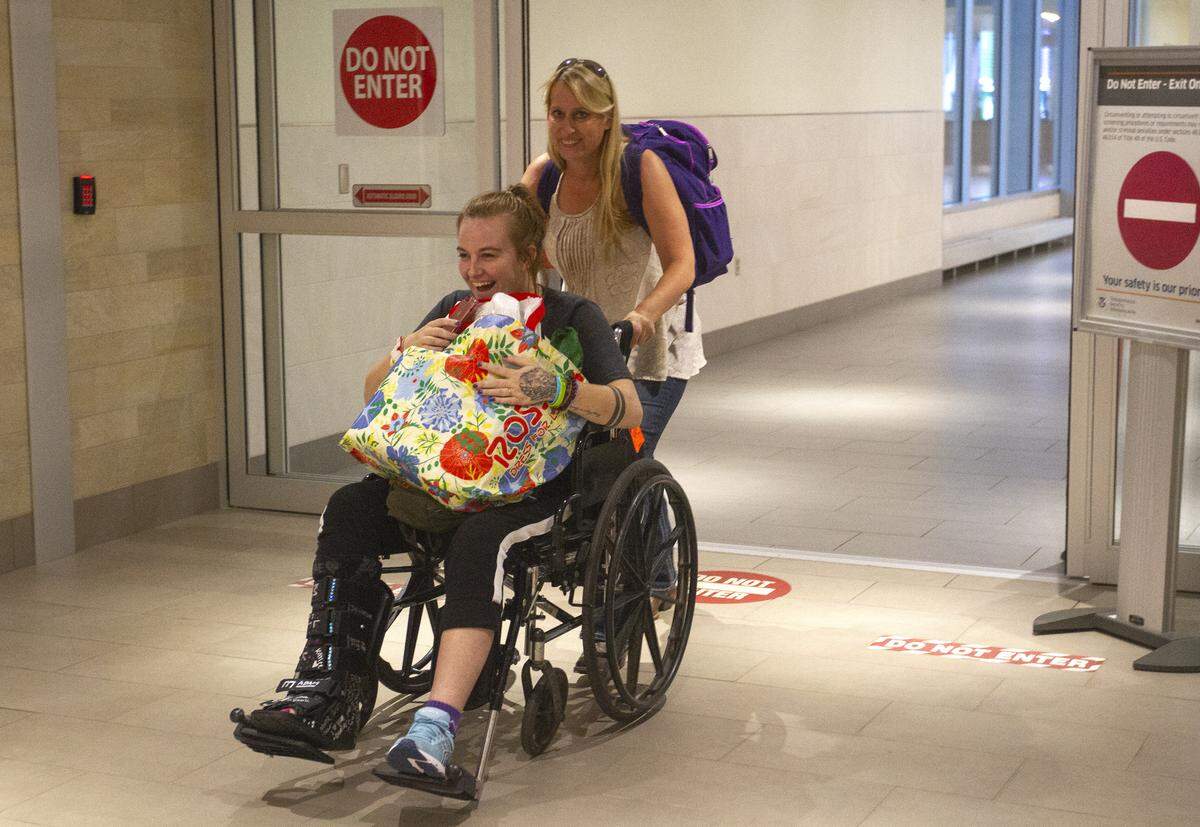 Danika Whitsett arrives home from Arizona on Wednesday night at the Tri-Cities Airport. Whitsett was injured July 13 when she was asleep in the SUV she was riding in when the driver, lost control and the car rolled about 40 miles outside of Phoenix.