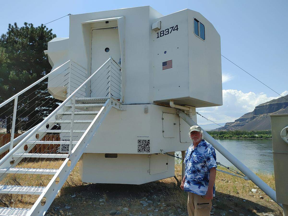 Kurt Hughes, a Seattle naval architect originally from Royal City, poses outside the Lunar Lander Dwelling tiny house he built as a getaway in Beverly, Wash.