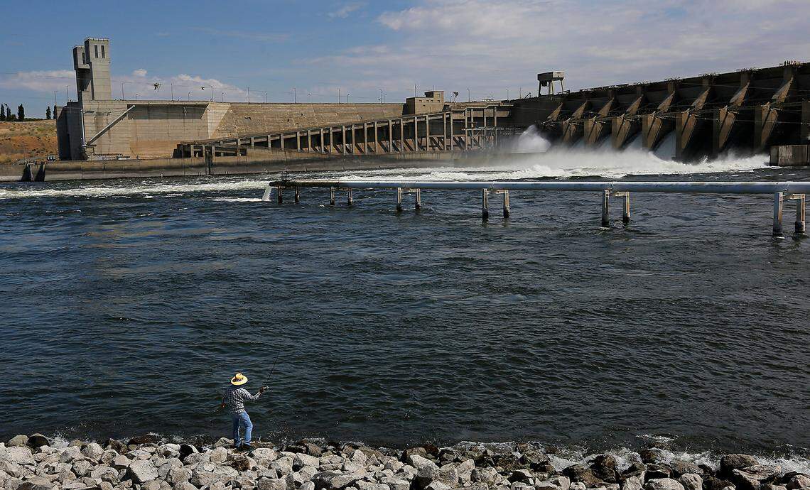 An angler casts for smallmouth bass below the spillways at Ice Harbor Dam on the Walla Walla County shoreline of the Snake River.