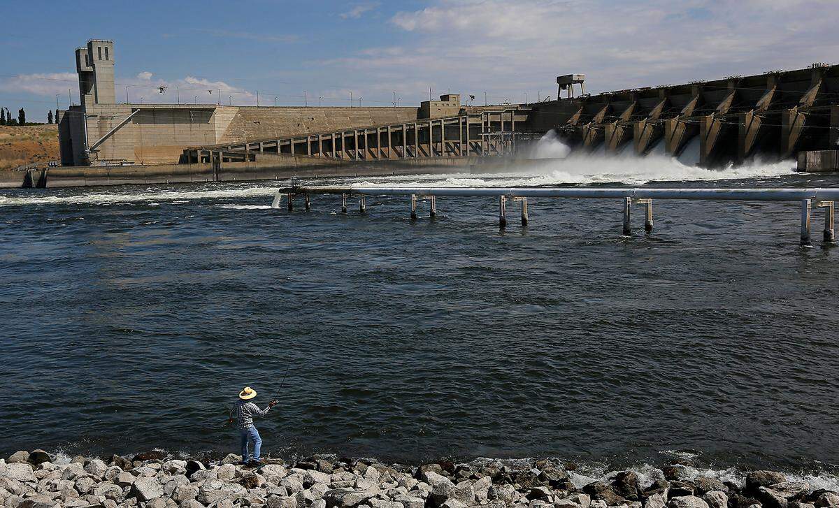 An angler casts for smallmouth bass below the spillways at Ice Harbor Dam on the Walla Walla County shoreline of the Snake River.
