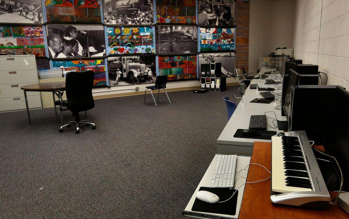 A 36-panel art piece, entitled “Weaving a Life Together,” shows historic community moments in black and white interlaced with colorful art. It was created by Leadership Tri-Cities.