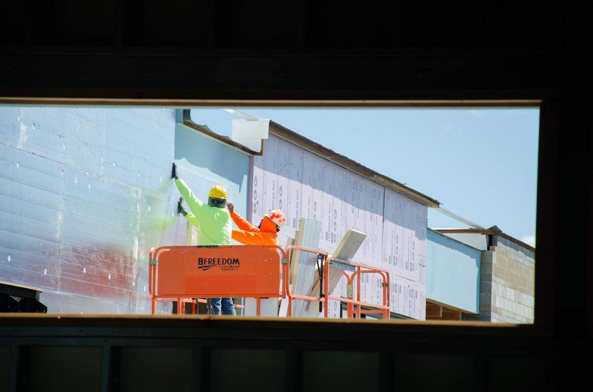 Construction crews use a lift to perform exterior work on Sageview High School during a Tuesday, May 7, 2024, tour of the school.