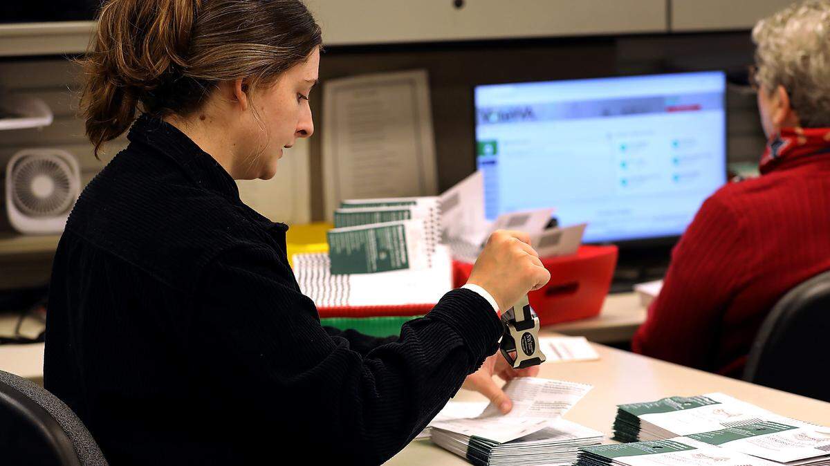 A Franklin County election worker date stamps ballots as part of the verification process in 2024.