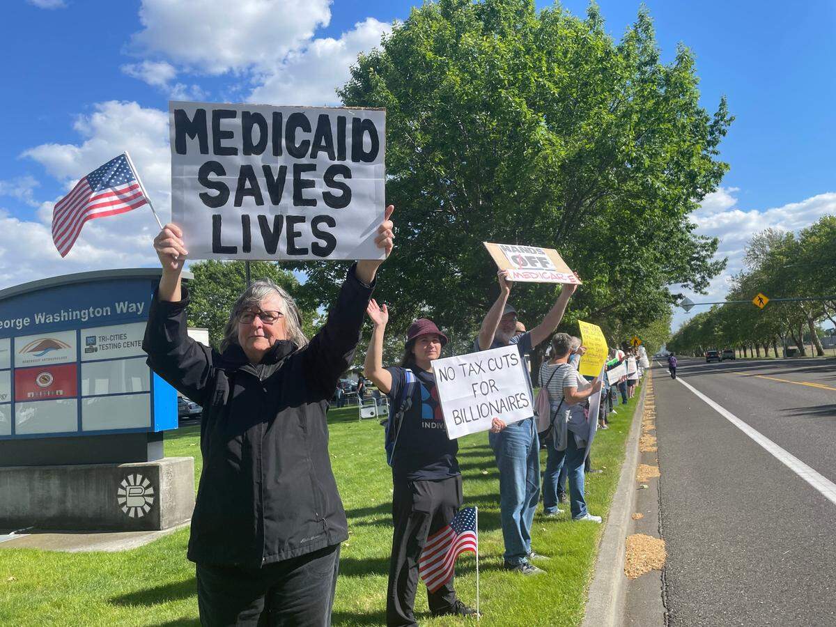 Protesters with Indivisible Tri-Cities picket against Medicaid cuts outside U.S. Rep. Dan Newhouse’s office in Richland, Washington.