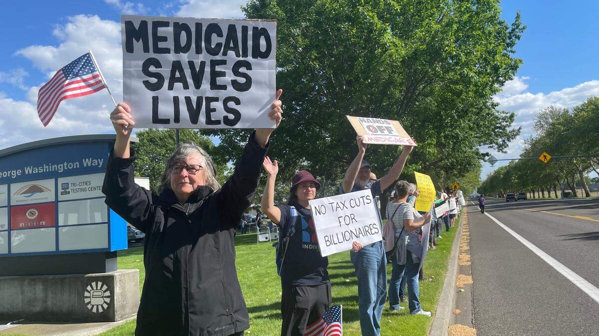 Protesters with Indivisible Tri-Cities picket against Medicaid cuts outside U.S. Rep. Dan Newhouse’s office in Richland, Wash., on May 14.