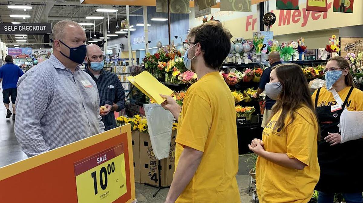 Workers at the Fred Meyer in Richland and community supporters deliver a letter to store director Matt Nellor regarding an attempt to unionize under United Food and Commercial Workers Local 1439.