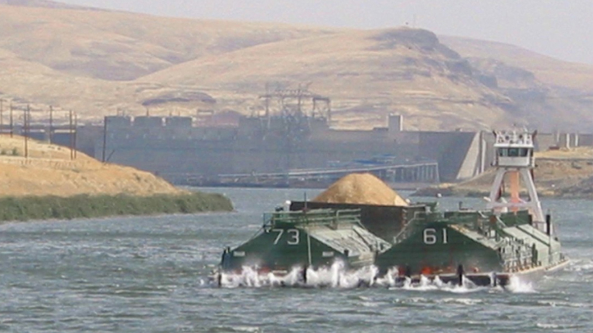 A barge travels the lower Snake River near Little Goose Dam by Starbuck.