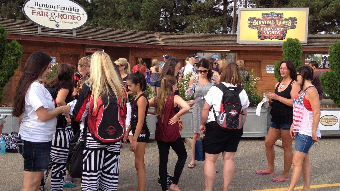 Fair-goers line up at the main gate of the Benton Franklin Fair &
Rodeo for the opening of the fair Tuesday morning in Kennewick.