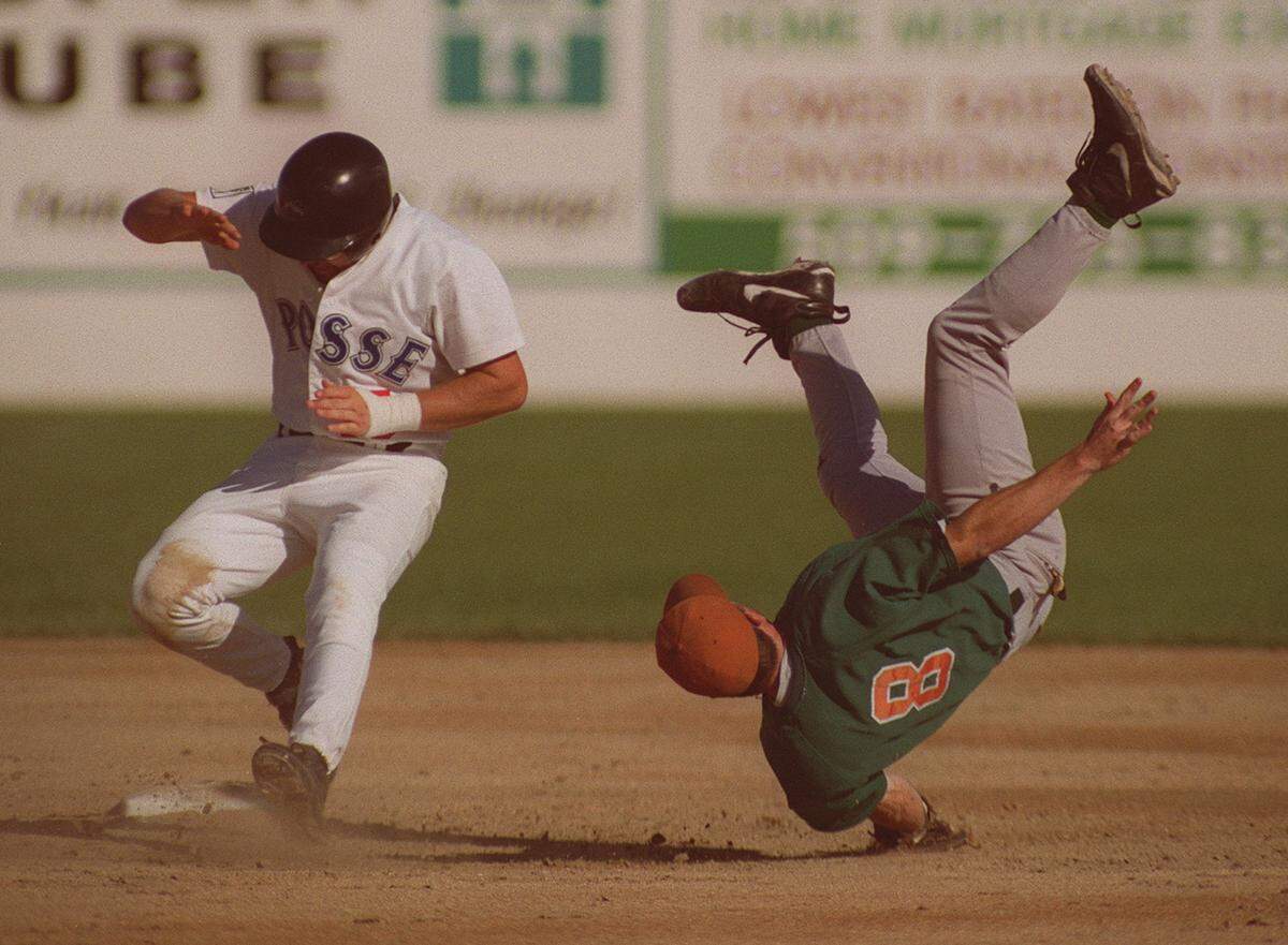 Salinas shortstop Sean Davisson (8) falls to the ground in the third inning after being upended by Tri-City's Rob Martin, who was safe on the play after stealing second base.