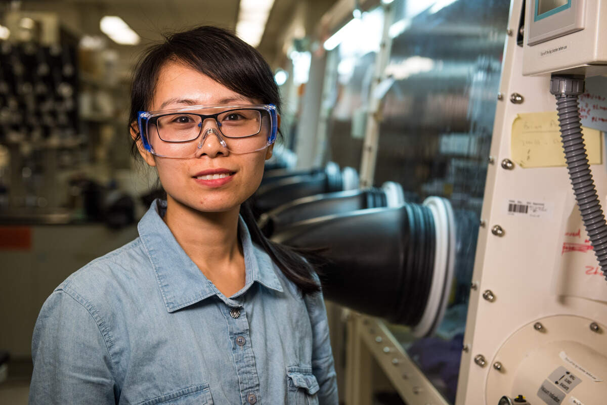 Researcher Huilin Pan uses a glovebox in the Materials Development Laboratories to assemble a lithium-sulfur coin cell battery. Lithium-sulfur batteries hold two times the energy of batteries on store shelves, but their charge is often short lived. PNNL has developed solutions to protect the anode and stabilize the cathode, and is working to bring them to real-world applications.