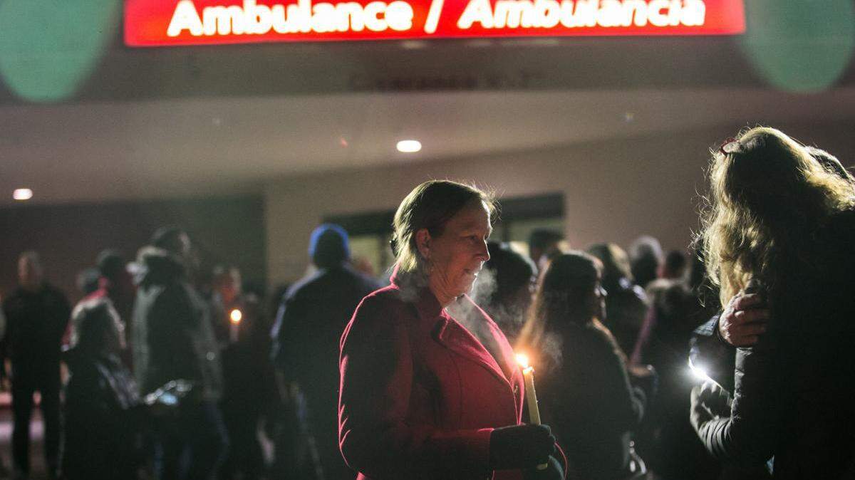 Standing in front of the Emergency Deptartment doors, Valda Longsine holds a lit candle in memory of her time at Astria Regional Medical Center on Jan. 13 in Yakima.