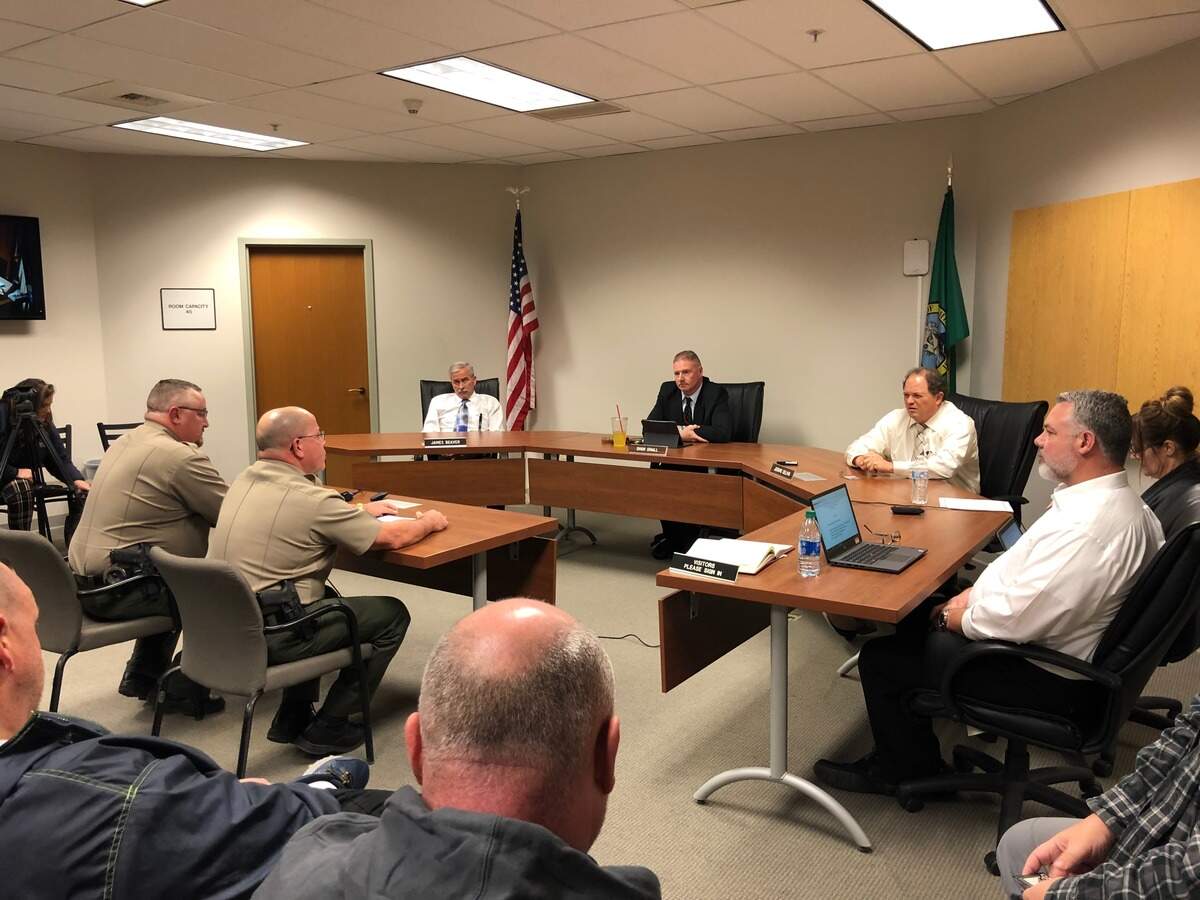 Capt. Josh Shelton and Commander Scott Souza, seated on the left, address the Benton County commissioners and county staff during a special meeting Tuesday about the new Benton County Corrections Department. Souza said employee morale has been good since commissioners removed control of the facility from Sheriff Jerry Hatcher.