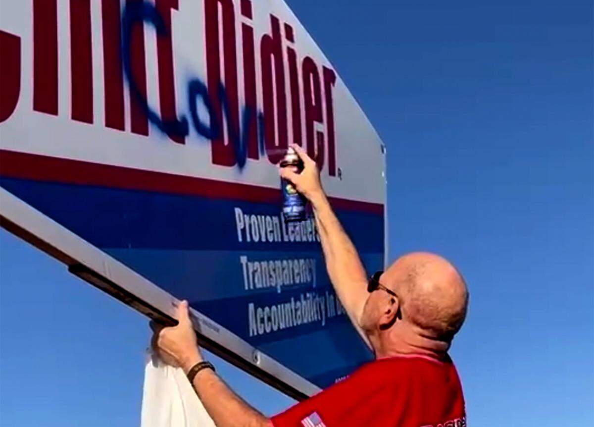 Steve Bauman with the Franklin County Republican Party recorded Michael Harrington, 68, of Pasco, spray painting “COVID Clint” on Commissioner Clint Didier’s campaign sign on Road 68 in Pasco.