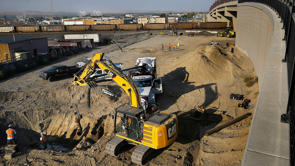 What are crews digging up now near the $40.6M Lewis Street bridge project in Pasco?