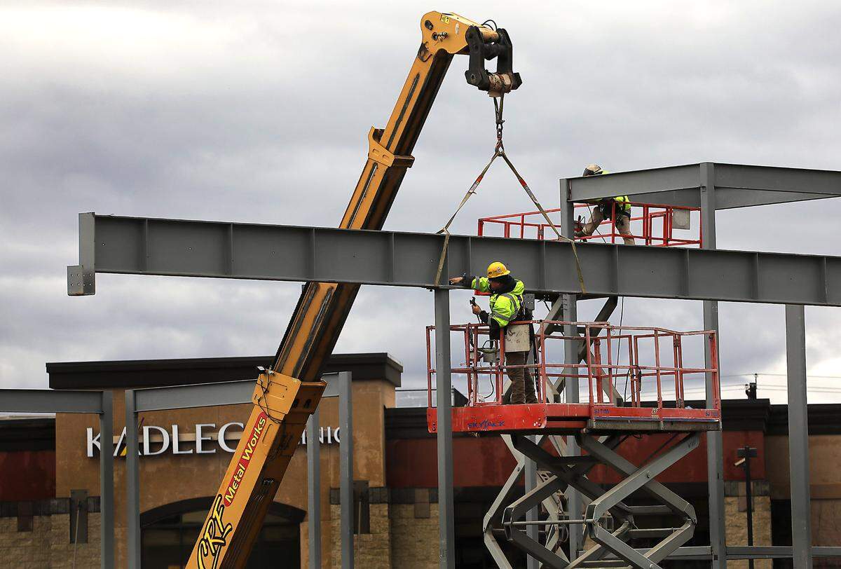 Ironworkers from CRF Metal Works assemble the steel frame for a new office building being constructed for Alisheva Law off Zintel Way in Kennewick.