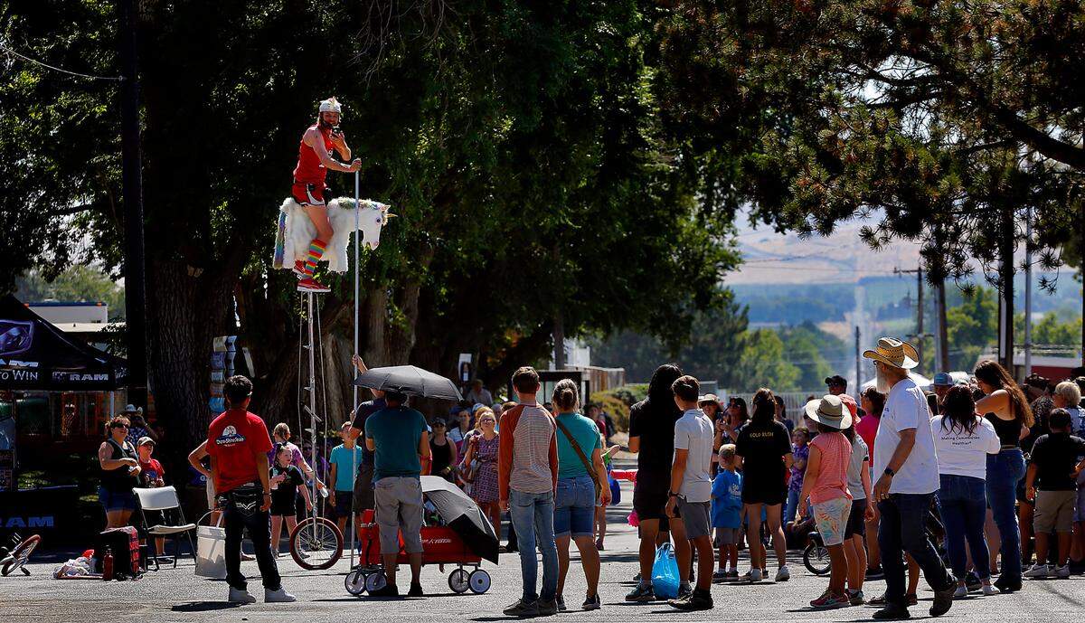 Jamey Mossengren, also known as The Unicycling Unicorn, attracts a crowd of fairgoers at the Benton Franklin Fair & Rodeo in 2022. The fair kicked off Tuesday, Aug. 19, 2025.