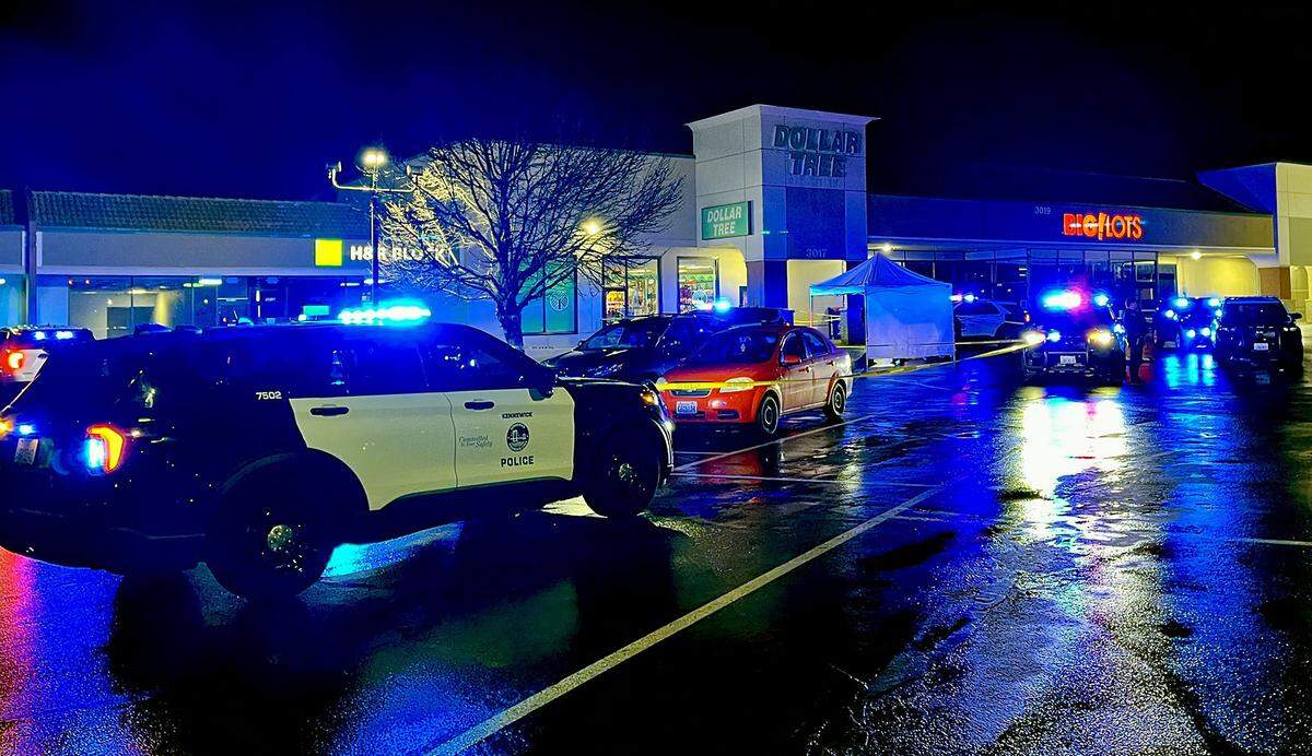 Kennewick police officers investigate a fatal stabbing Monday night in the Dollar Tree parking lot.