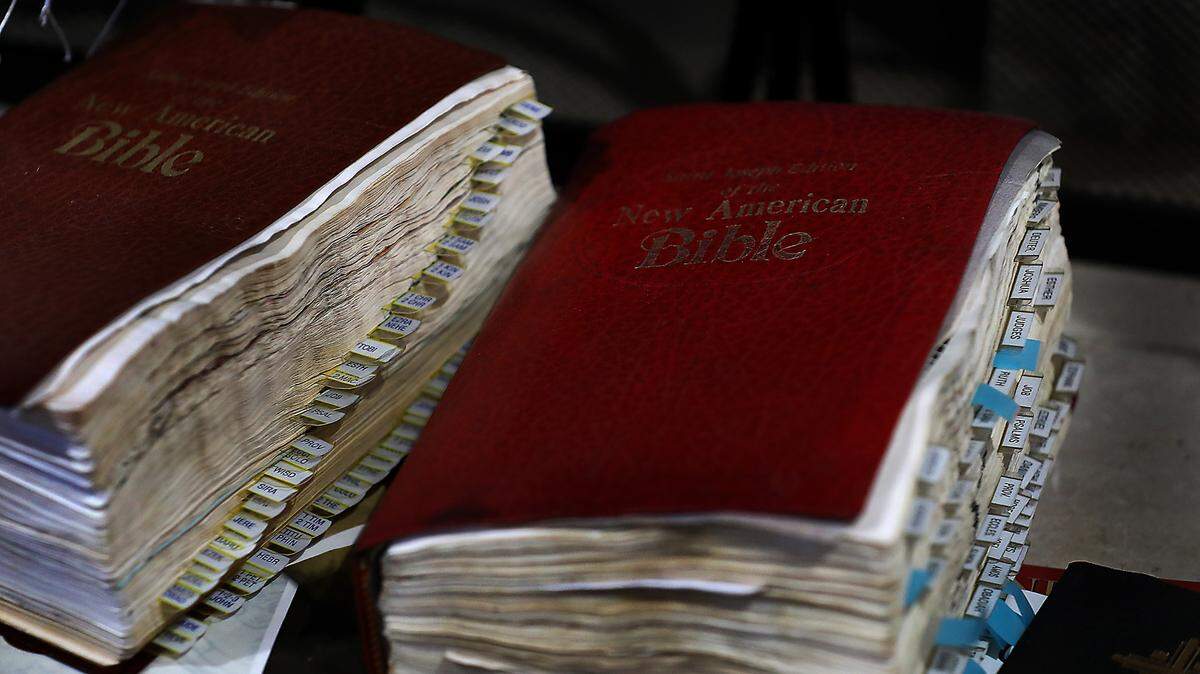 A pair of well-used Bibles belonging to Lillian and Ernesto Parra sit on the fireplace hearth of their temporary Pasco home. The damaged Bibles were among the very few personal items recovered from their fire-damaged home.