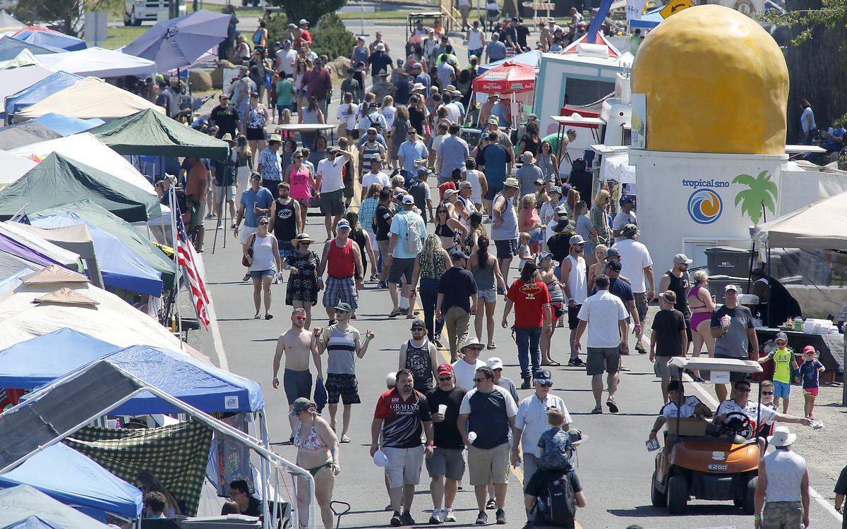 Unlimited hydroplane racing fans mingle as they walk through Kennewick’s Columbia Park during the 2019 Tri-Cities Water Follies boat races and airshow event. About 65,000 people attend the annual event.