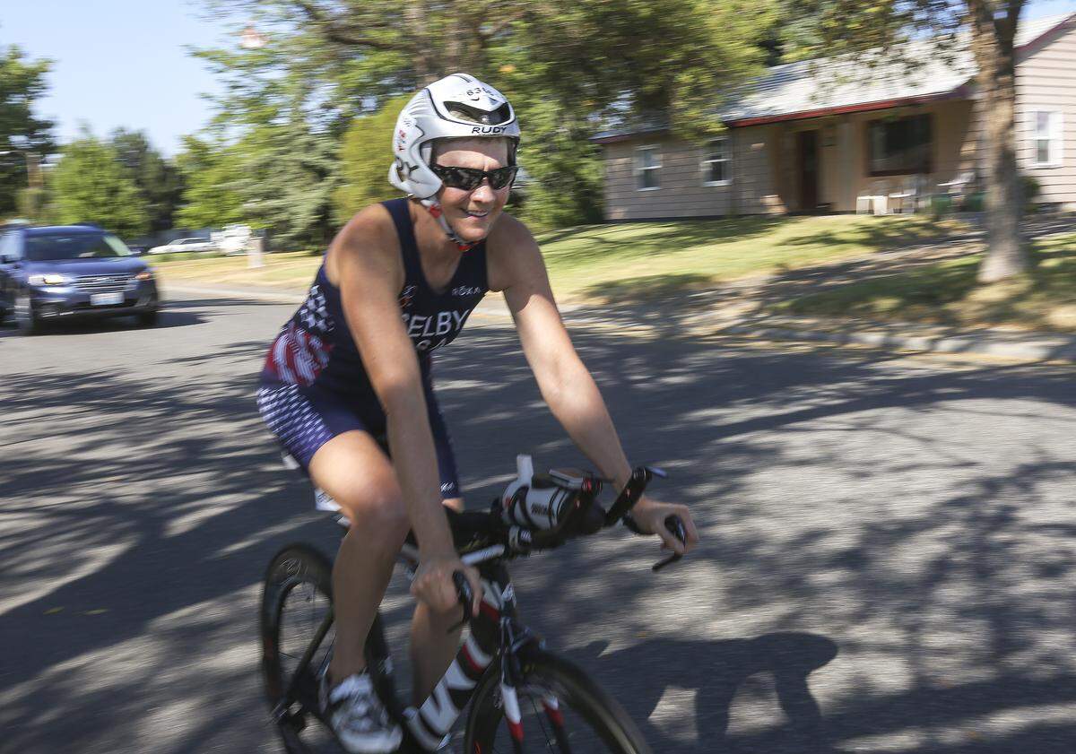 Lori Selby rides her bike around her neighborhood in Richland.  Selby represented the United States last month in the Aquabike in the ITU Multisport World Championships Festival in Odense, Denmark. She finished sixth.