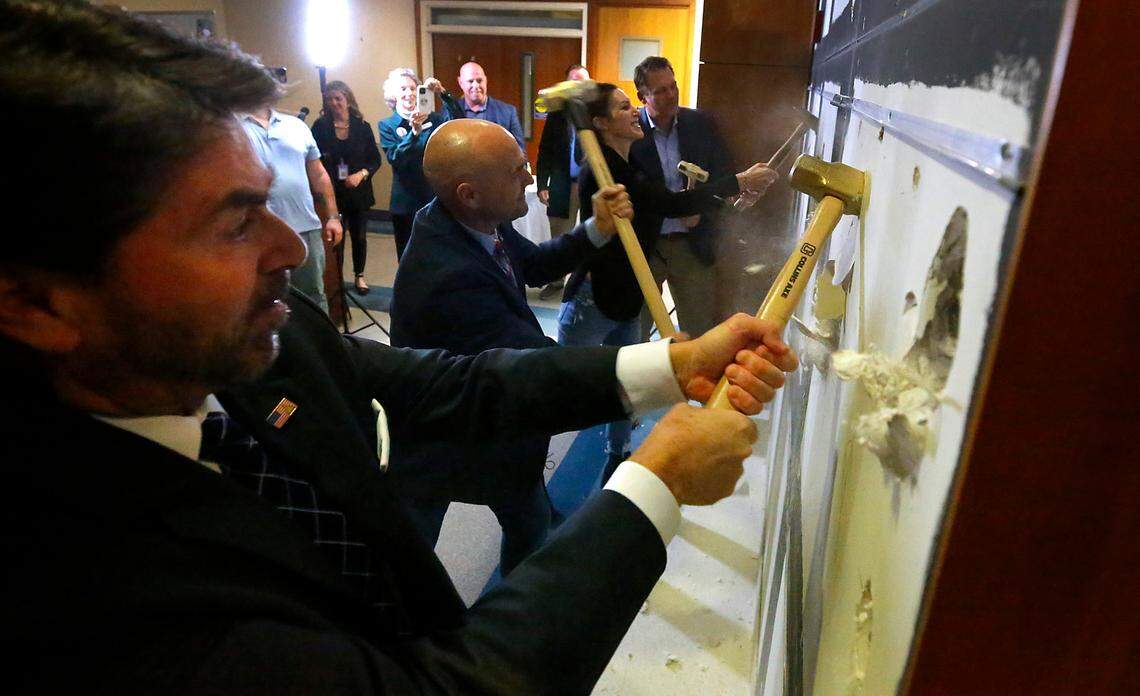 Local officials take turns swinging sledge hammers at a wall during the “groundbreaking” ceremony for the Columbia Valley Center for Recovery in the former KGH hospital in downtown Kennewick.