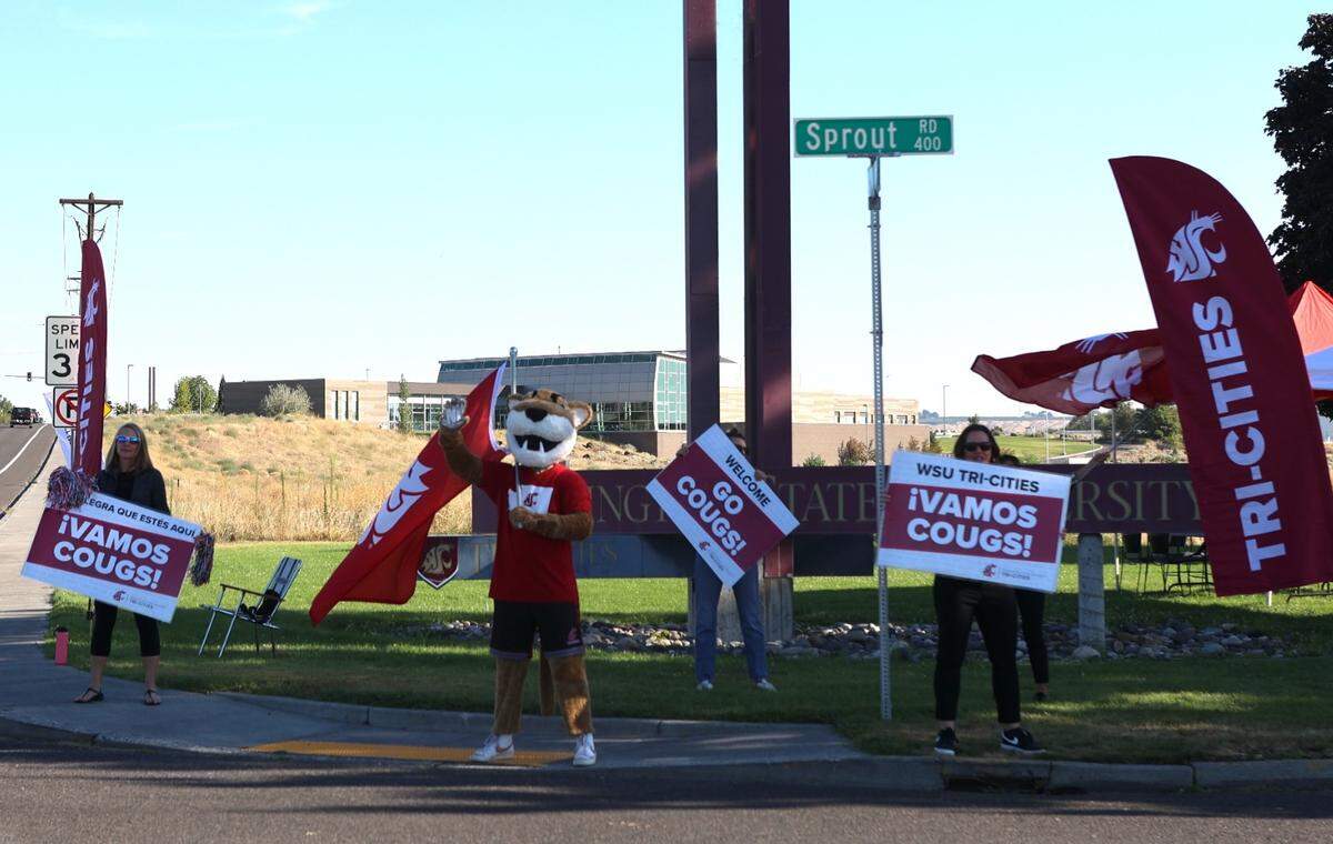 WSU’s mascot, Butch, waves a flag Monday as students enter campus for their first day at the Tri-Cities campus.
